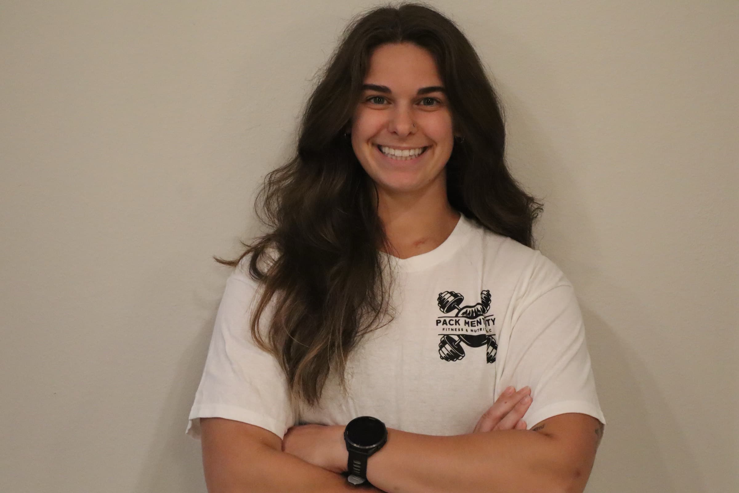 Gabrielle Richards, founder of Pack Mentality, in a Pack Mentality Fitness & Nutrition shirt